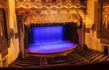 View of the Warner Grand Theatre from the balcony with purple stage lights
