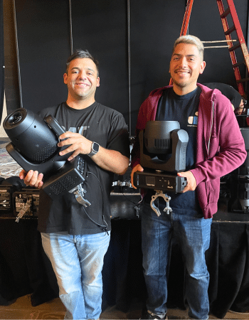 David and Andrew holding new lighting equipment being installed in the Grand Annex Music Hall