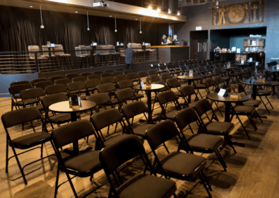 The main audience space with a mix of tables and chairs set up