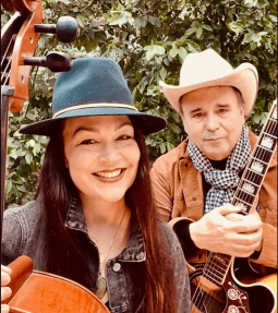 Erin and James of Great Willow holding their cello and guitar