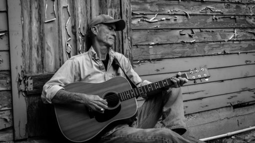 Emily and Chris Huff with the Grand Annex Arts Saloon wooden sign